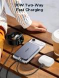 Promotional scene showing a 30W two-way fast charging setup with a smartwatch, iPhone and wireless earbuds on a wooden bench.