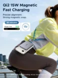 Advertisement for Qi2 15W magnetic fast charging, showing a cyclist with a magnetically attached phone charger and battery graphics.