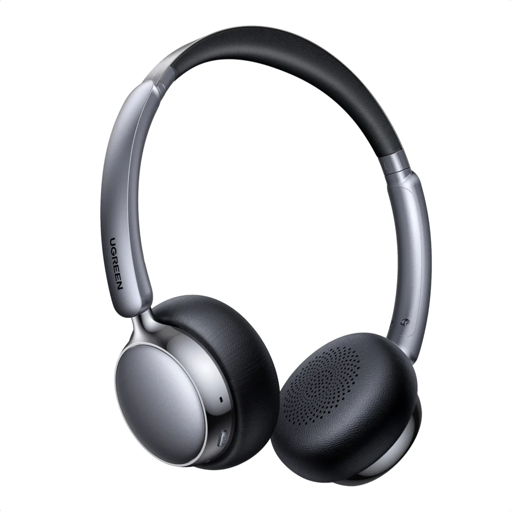 Close-up of silver and black over-ear headphones with cushioned ear cups and padded headband.",
